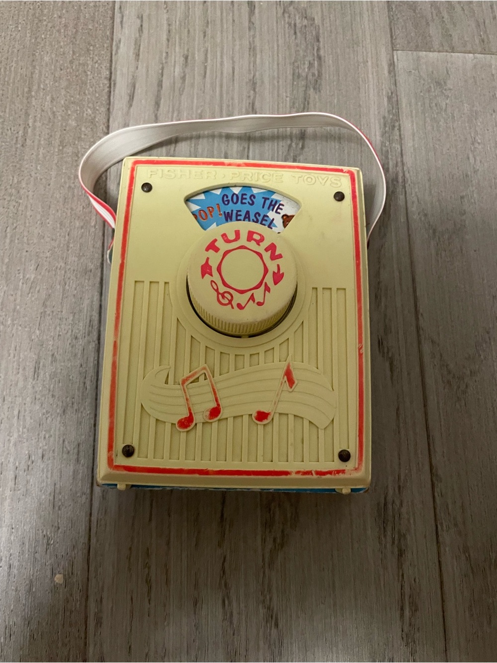 Fisher-Price Cream and Red Portable Turn-Knob Music Toy